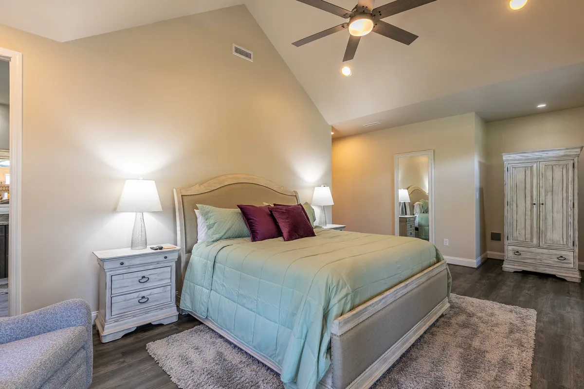 A serene bedroom highlighted by a plush king-sized bed, nightstands, a lounge chair, and a wardrobe. The room exudes tranquility, making it ideal for restful mornings or winding down with a book, emphasizing the sense of comfort and privacy described in the section.